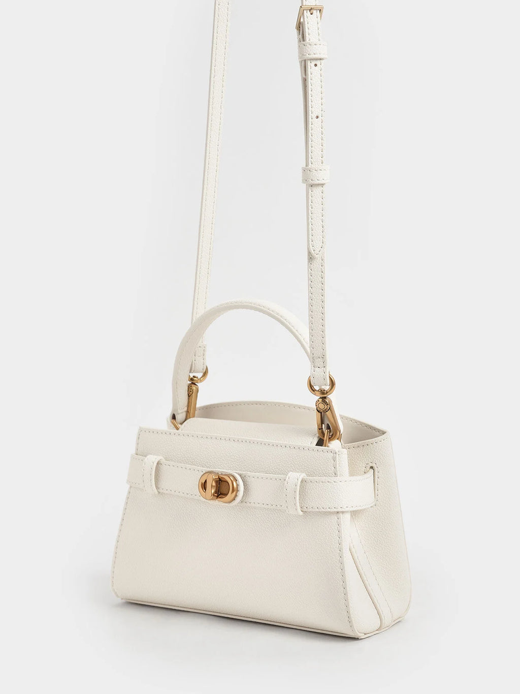 Aubrielle metallic-buckle top handle bag in cream