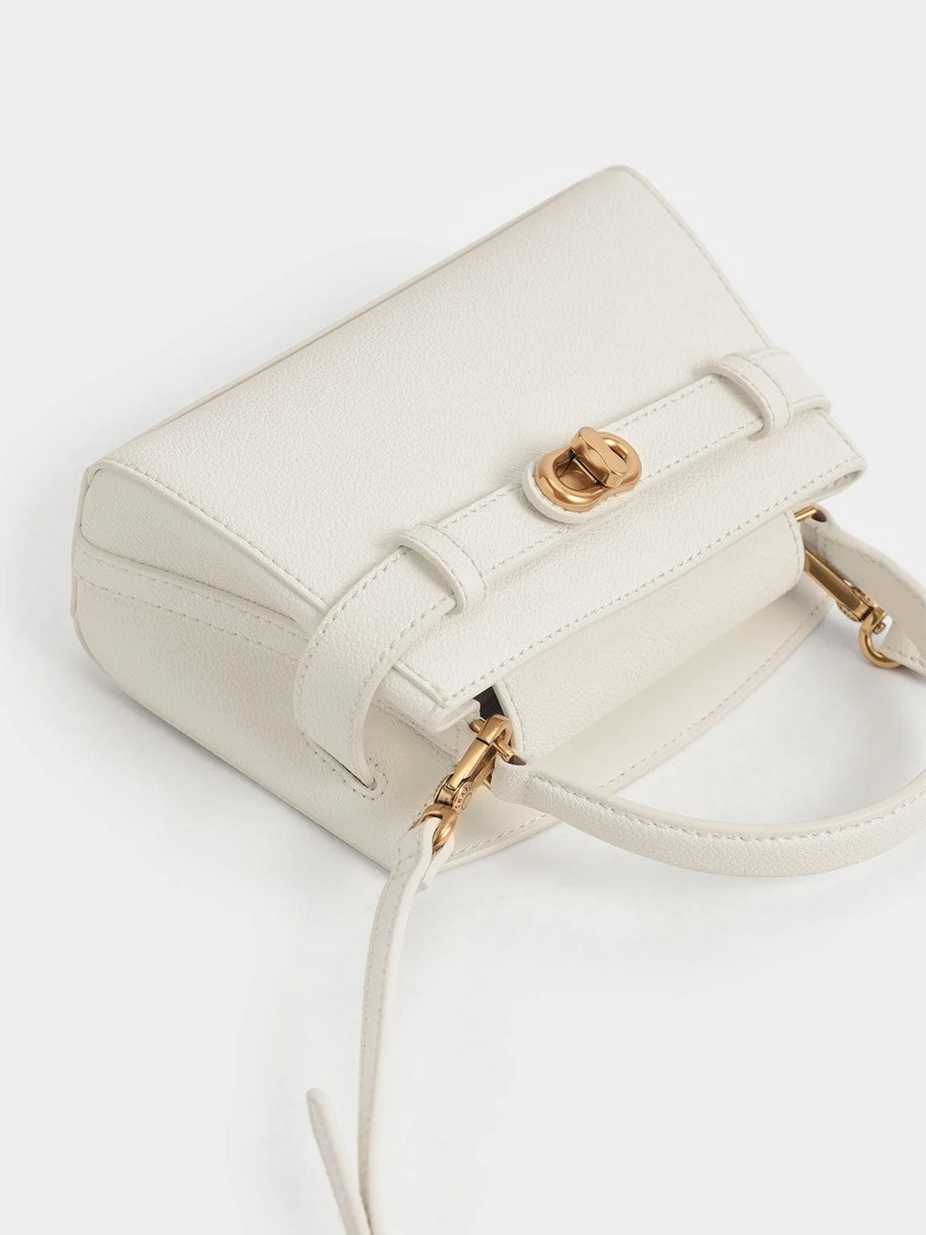 Aubrielle metallic-buckle top handle bag in cream