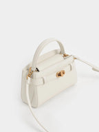 Aubrielle metallic-buckle top handle bag in cream