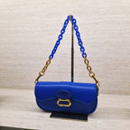 Daki belted curved bag in a vivid cerulean blue finish