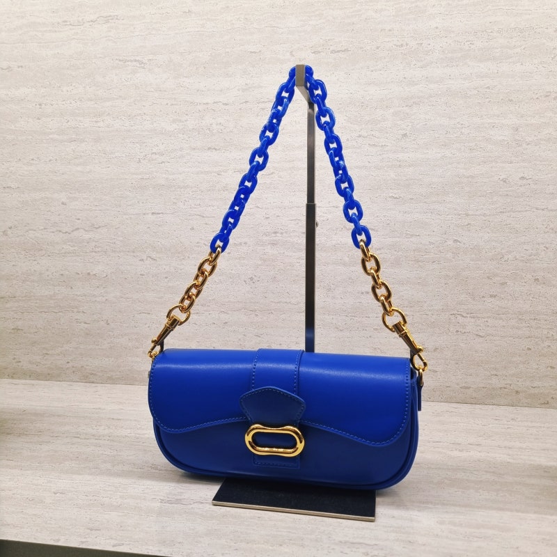 Daki belted curved bag in a vivid cerulean blue finish