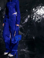 Daki belted curved bag in a vivid cerulean blue finish